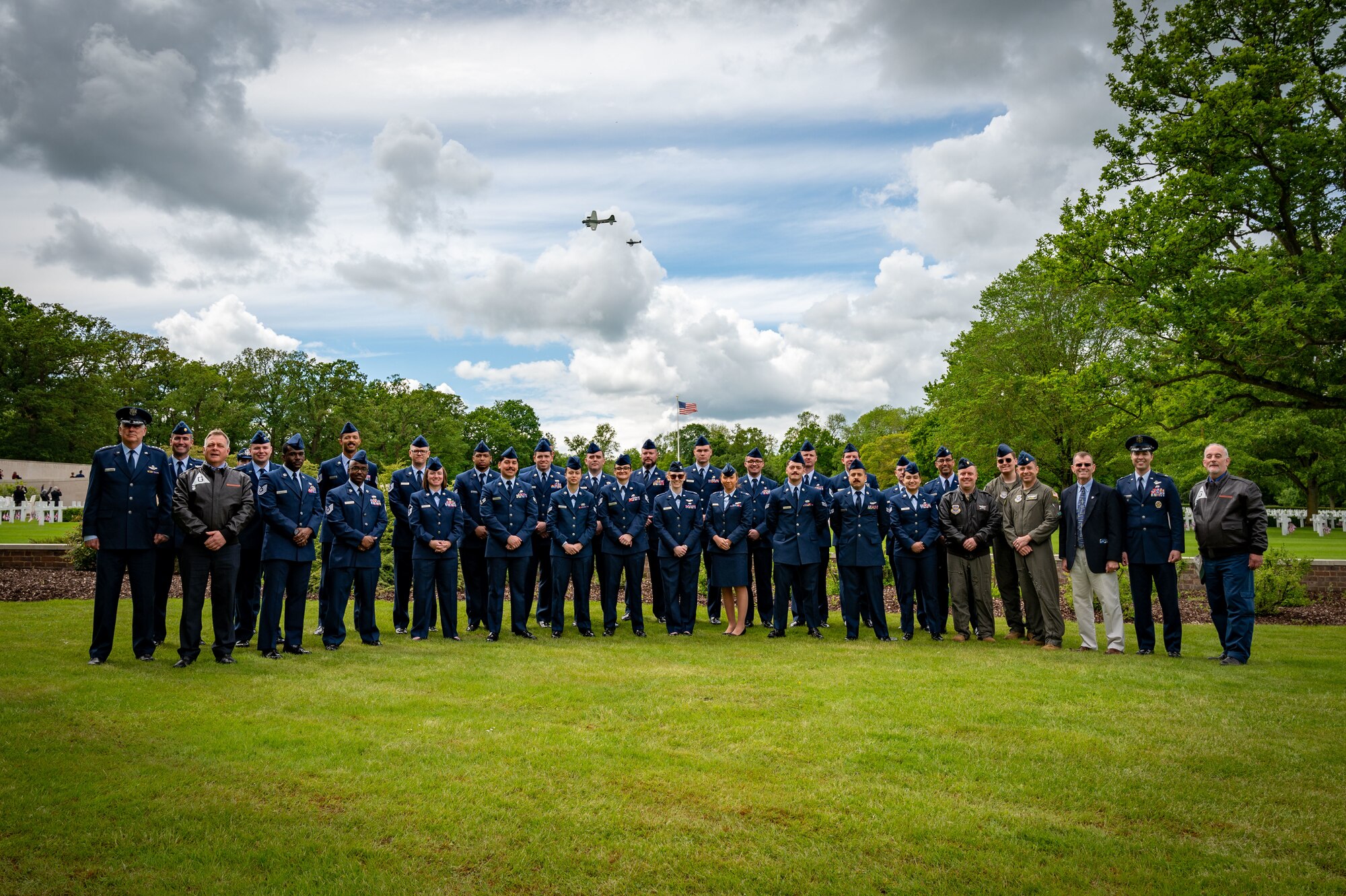 U.S. Air Force Gen. Mike Minihan, commander of Air Mobility Command, poses with Airmen from the 305th Air Mobility Wing and historians Ian White and Peter Hill from the 305th Bombardment Group Memorial Association at the Cambridge American Cemetery, England, May 27, 2024. The 305th AMW hosted its heritage trip for the third consecutive year to learn about its forebearer, the 305th BG, who was crucial to the nation’s triumph against Nazi Germany in World War II. (U.S. Air Force photo by 2nd Lt. Alexis Kula)