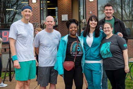 base command leadership and Sexual Assault Prevention and Response team pose for a photo at start of 5K