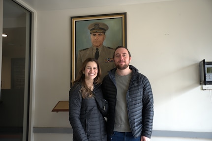 Furnari family descendants pose in front of a portrait of their great grandfather Biagio O. Furnari