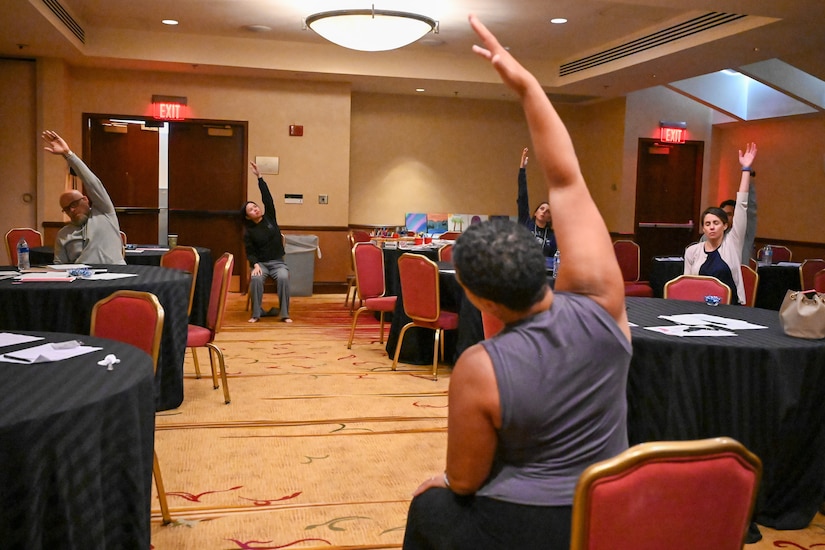 Larisa Harrington, wellbeing coach at Strong By Nature Wellness, leads a yoga session for participants of the Joint Base Anacostia-Bolling wellness retreat weekend in Herndon, Virginia on May 4, 2024. The session was designed to improve, strengthen, balance, and promote mental clarity. (U.S. Air Force photo by Airman Shanel Toussaint)