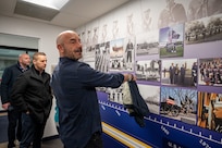 Furnari family member points to a photo of his grandfather Biagio O. Furnari on display at the U.S. Navy Ceremonial Guard Headquarters building