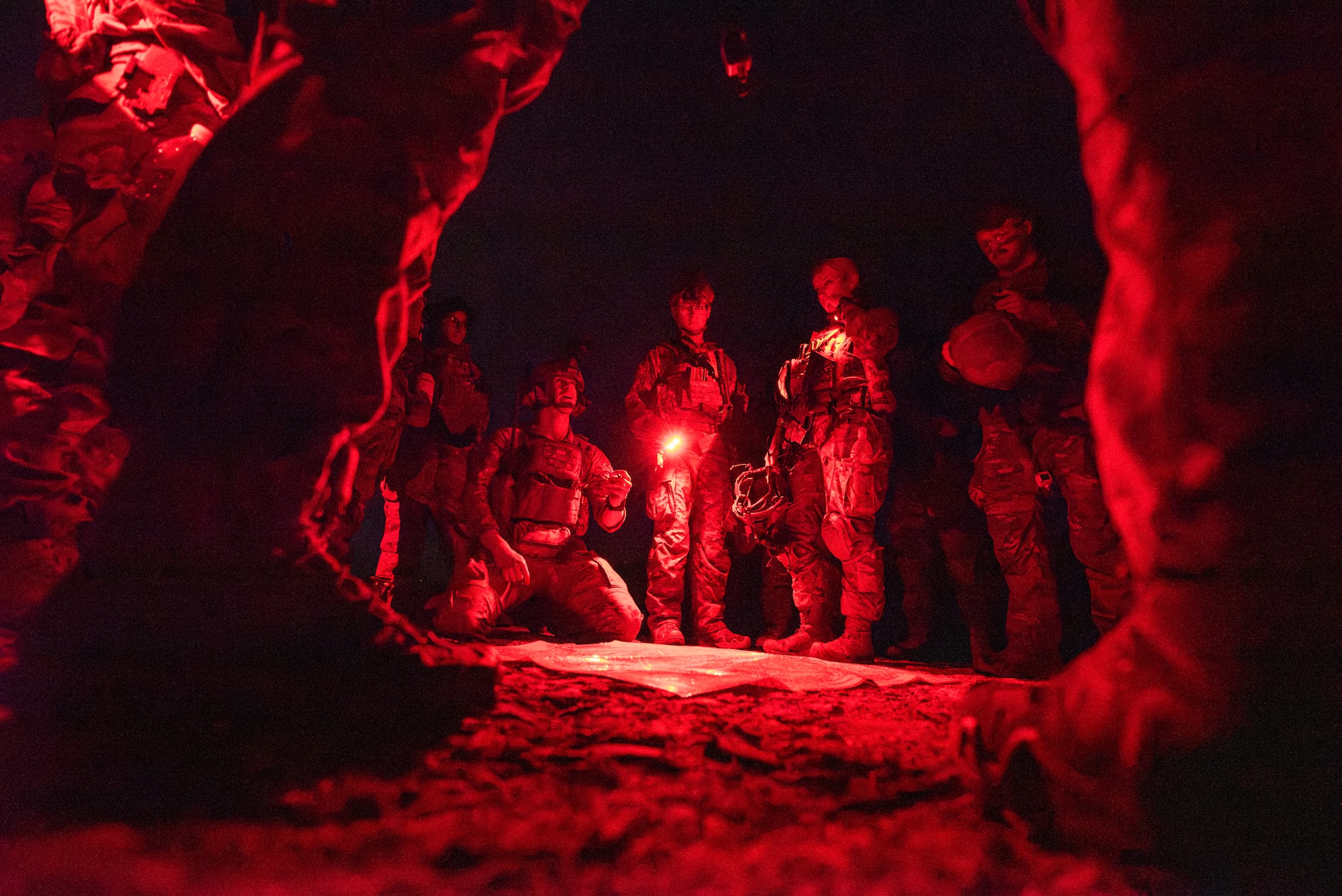 U.S. Air Force Staff Sgt. William Smith, 435th Security Forces Squadron Creek Defender Ground Combat Regional Training Center instructor, center left, teaches students on patrol route tactics during a night training operation