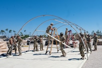 The Air Force District of Washington Team builds a shelter from the ground up during a deployment exercise on day three of the Readiness Challenge X at Tyndall Air Force Base in Panama City Beach, Florida, on April 24, 2024. This challenge prioritizes preparedness, innovation, and team work throughout the different challenges Airmen have to face throughout the training experience. (U.S. Air Force photo by Airman Shanel Toussaint)