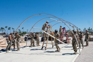 The Air Force District of Washington Team builds a shelter from the ground up during a deployment exercise on day three of the Readiness Challenge X at Tyndall Air Force Base in Panama City Beach, Florida, on April 24, 2024. This challenge prioritizes preparedness, innovation, and team work throughout the different challenges Airmen have to face throughout the training experience. (U.S. Air Force photo by Airman Shanel Toussaint)