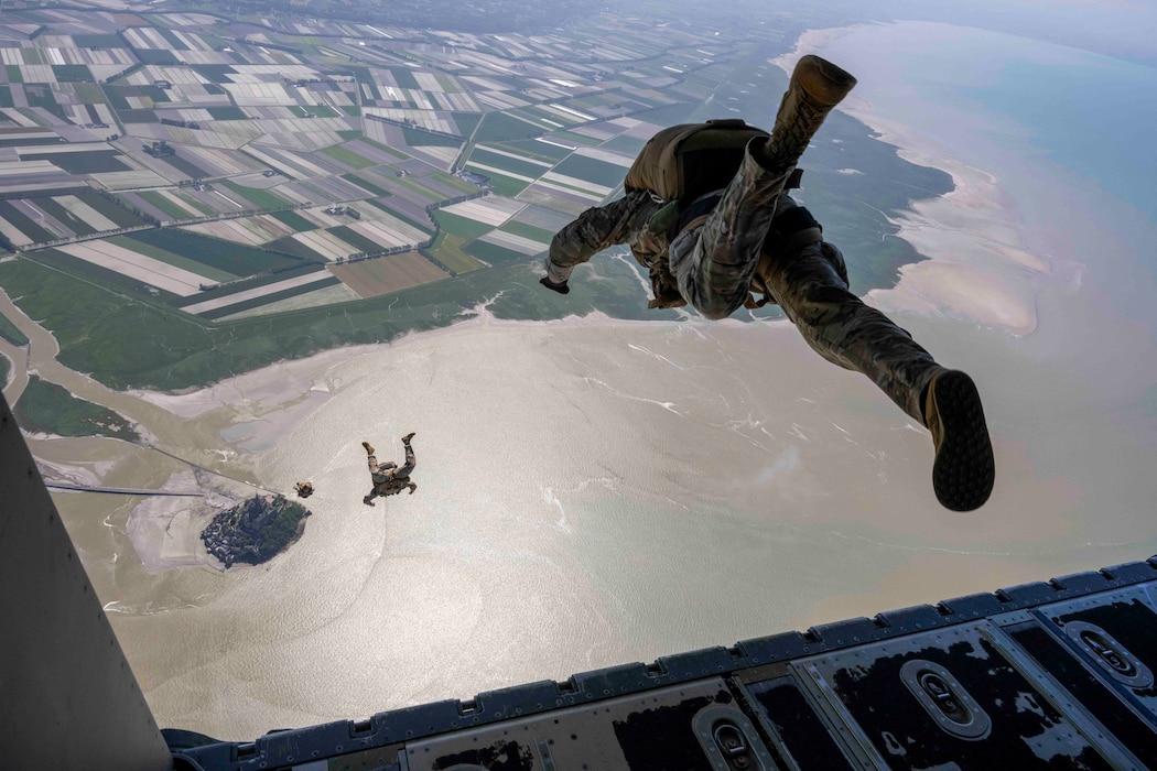 U.S. Air Force special tactics Airmen assigned to the 57th Rescue Squadron jump out of a MC-130J Commando II