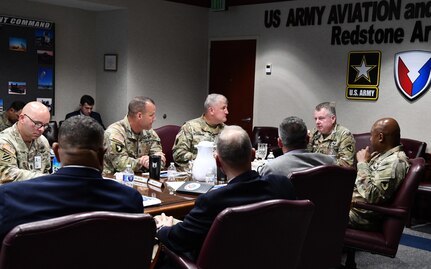 Soldiers around a table talking.