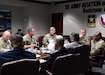 Soldiers around a table talking.