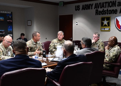 Soldiers around a table talking.