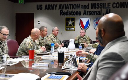 Soldiers around a table talking.