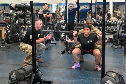 Tierra Taylor, fitness assessment cell technician, squats with 150 pounds of weight during the police week powerlifting competition at the fitness center on Joint Base Anacostia-Bolling, Washington, D.C., May 16, 2024. Taylor was one of four women who competed in the challenge and won the middle weight category. (U.S. Air Force photo by Airman Shanel Toussaint)