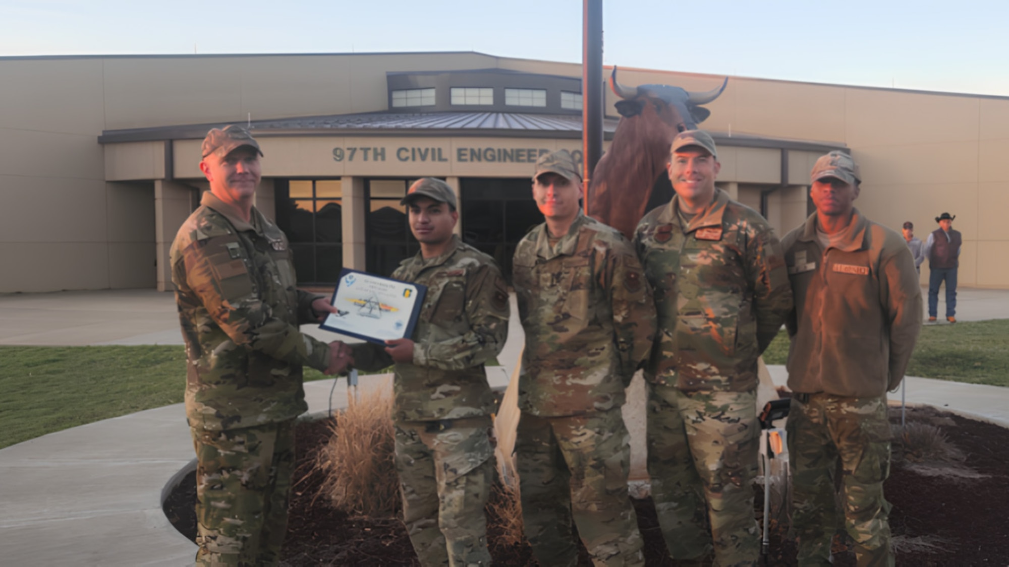 U.S. Air Force Colonel Jeffery Marshall, 97th Air Mobility Wing commander, awards Senior Airman Anjal Shrestha, 97th Civil Engineer Squadron structural sub-asset management plan manager, with Altus Airman of the Month at Altus Air Force Base, Oklahoma, March 2024. Some of Shrestha’s job duties are identifying structural assets in need of enhancement and figuring out the best strategy for maintenance or replacement. (Courtesy photo)