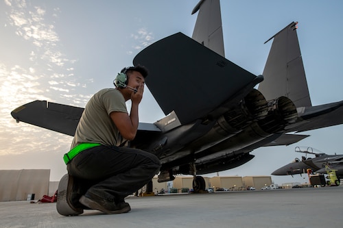 A F-15E Strike Eagle crew chief, assigned within the U.S. Central Command area of responsibility, goes through pre-flight checks