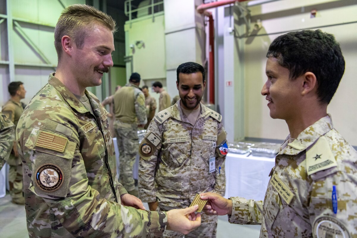 U.S. Airman trades patches with a member of the Royal Saudi air force