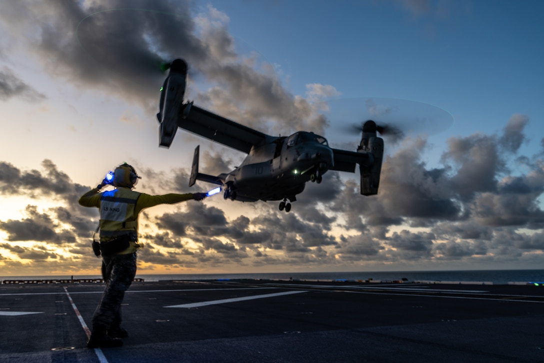 Royal Australian Navy Leading Seaman Joshua King, a flight deck marshal assigned to HMAS Adelaide, signals U.S. Marines with Marine Medium Tiltrotor Squadron 268, Marine Rotational Force – Darwin 24.3, for take off in an MV-22B Osprey from the flight deck of HMAS Adelaide as part of deck landing qualifications during a Wet and Dry Exercise Rehearsal, in the Arafura Sea, June 4, 2024.

 Marines and Sailors embarked on HMAS Adelaide (L01) alongside their Australian Allies to participate in WADER, transiting from Darwin to Townsville from June 2-20, 2024. During WADER, elements from the MRF-D Marine Air-Ground Task Force will conduct MV-22B Osprey deck landing qualifications, a live-fire deck shoot, medical subject matter expert exchanges, enhance amphibious fires, command and control, and initiate a ship-to-shore movement in order to set conditions for future operational tasking.
