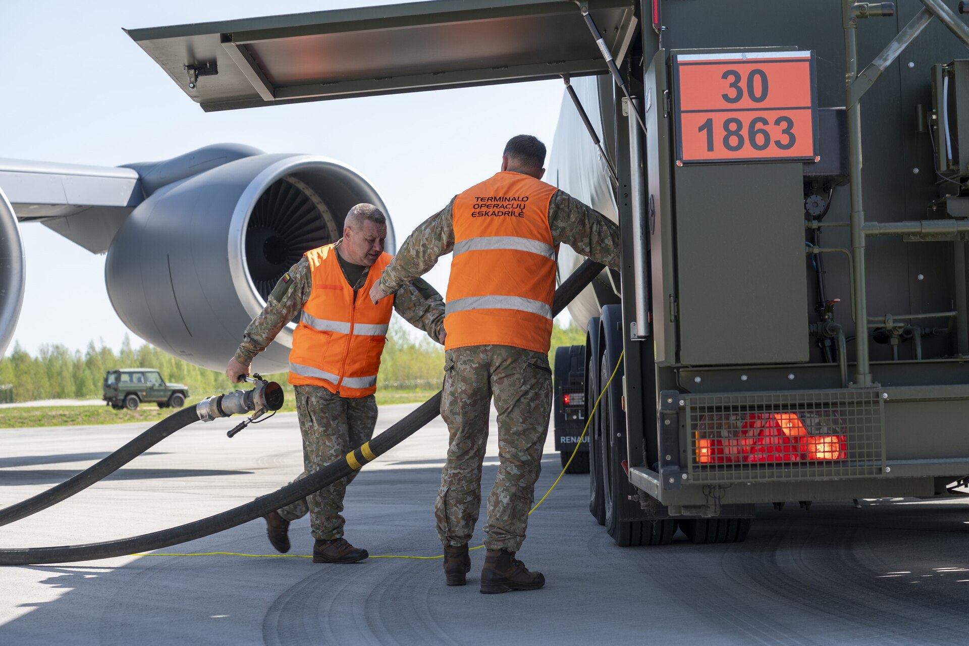 Two members from the 171st Air Refueling Wing, Pennsylvania Air National Guard, share best practices about hot pit refueling on a KC-135 Stratotanker aircraft with the Lithuanian Air Force during the most recent State Partnership Program engagement May 2, 2024, in Siauliai, Lithuania. Pennsylvania and Lithuania have been partner states for over 30 years. (U.S. Air National Guard photo by Tech. Sgt. Zoe M. Wockenfuss)