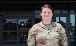 U.S. Army Spc. Anne Koller stands near the emergency entrance of Brooke Army Medical Center, June 4, 2024. Koller, a combat medic, attempted to save her neighbor from gunshot wounds he received the evening of Feb. 19, 2024. She applied improvised occlusive dressings until emergency medical technicians arrived. (DOD photo by Robert A. Whetstone)