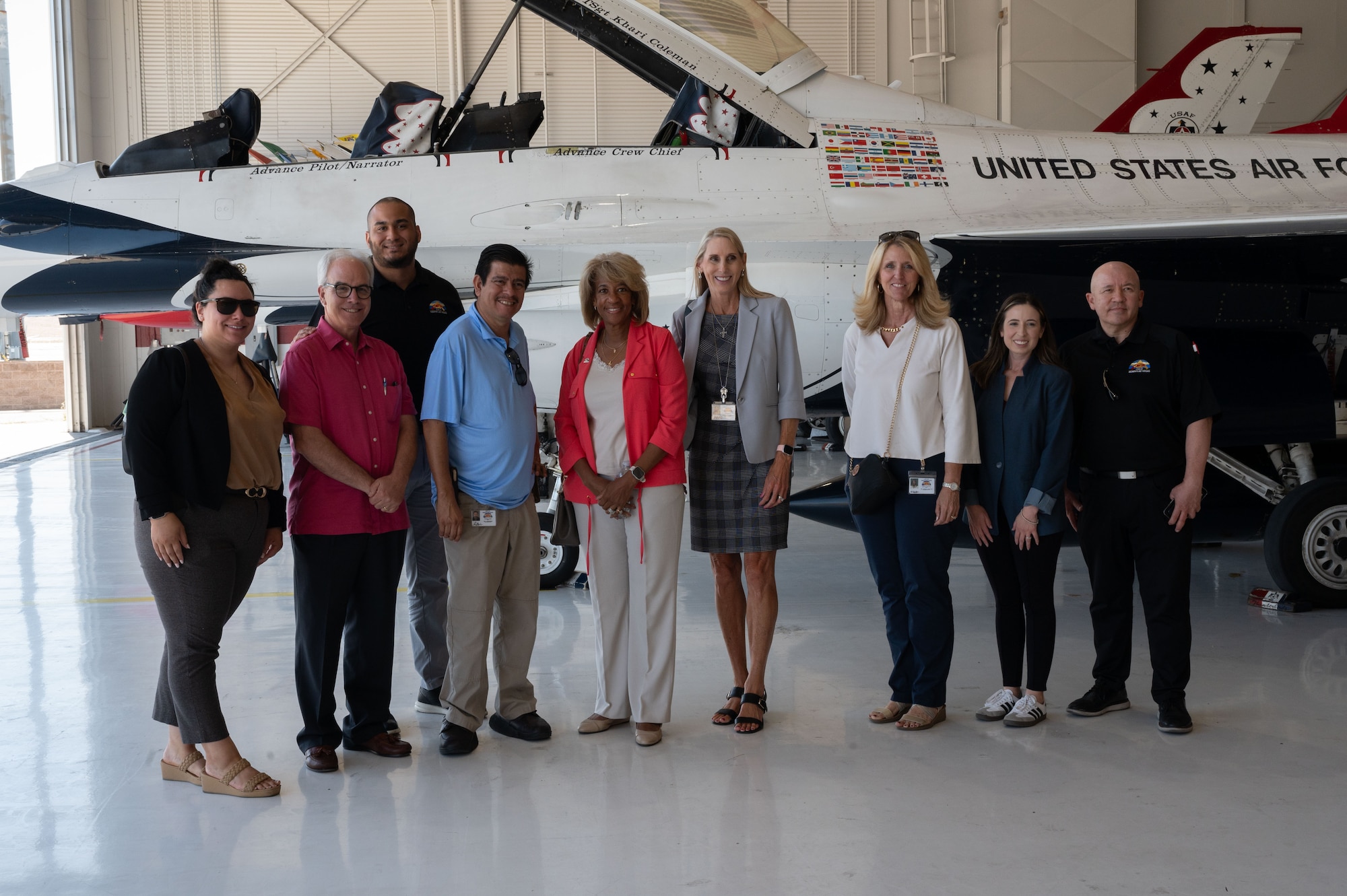 A group of people take a photo in front of an aircraft.