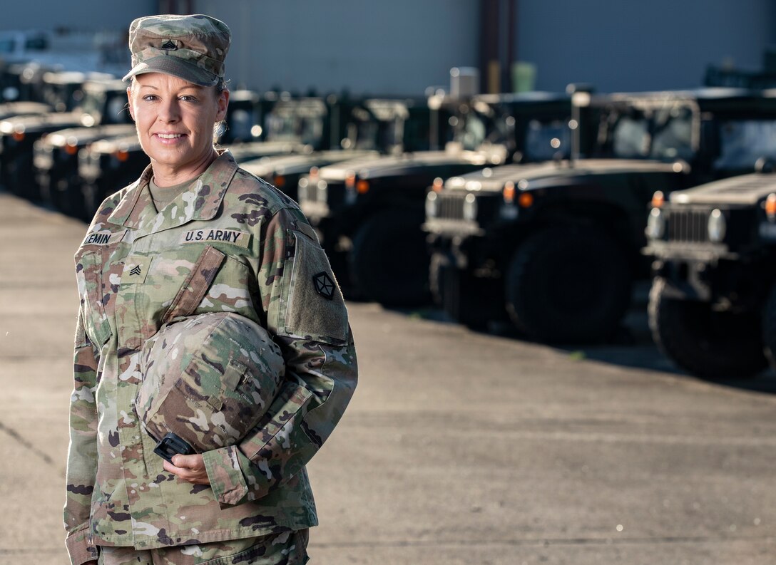 U.S. Army Sgt. Crystal Lemin, a master driver assigned to V Corps, stands in front of a line of Humvees, May 20, 2024, at Fort Knox, Kentucky. Lemin was handpicked to represent her unit at the 80th D-Day anniversary in Normandy, France, honoring the legacy of her great-great cousin, Master Sgt. Robert N. Lemin, who served with the 2nd Ranger Battalion. (U.S. Army photo by Sgt. Tyler Brock)
