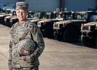 U.S. Army Sgt. Crystal Lemin, a master driver assigned to V Corps, stands in front of a line of Humvees, May 20, 2024, at Fort Knox, Kentucky. Lemin was handpicked to represent her unit at the 80th D-Day anniversary in Normandy, France, honoring the legacy of her great-great cousin, Master Sgt. Robert N. Lemin, who served with the 2nd Ranger Battalion. (U.S. Army photo by Sgt. Tyler Brock)