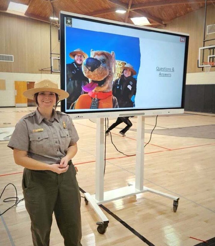 Holly Garnett, park ranger at John Martin Reservoir, stands in front of her slides after her National Engineer Week pitch to students at Lamar Middle School, in Lamar, Colorado.