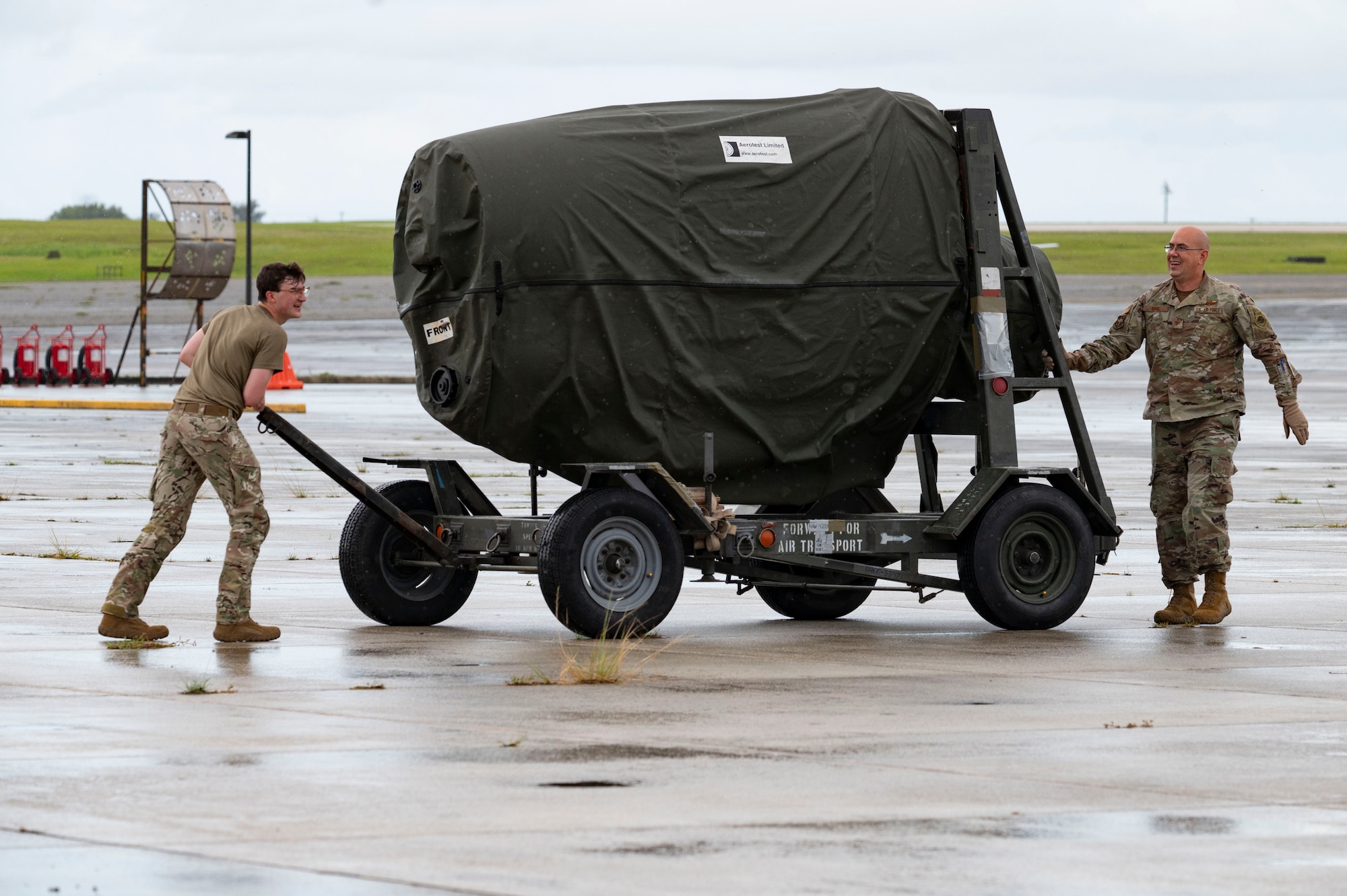 U.S. Air Force Col. Joshua Imme, 19th Airlift Wing deputy commander, and Senior Airman Tobin Moore, 40th Airlift Squadron loadmaster, unload cargo from a C-130J Super Hercules at Antonio B. Won Pat International Airport, Guam, June 5, 2024. Four C-130s assigned to Dyess Air Force Base, Texas, arrived in Guam to begin exercise Valiant Shield 2024. Exercises such as Valiant Shield allow the Indo-Pacific Command Joint Forces the opportunity to integrate forces from all branches of service and with our allies to conduct precise, lethal, and overwhelming multi-axis, multi-domain effects that demonstrate the strength and versatility of the Joint Force and our commitment to a free and open Indo-Pacific. (U.S. Air Force photo by Airman 1st Class Emma Anderson)