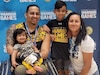 Retired Army Sgt. Joel Rodriguez, his wife Liannie - his caregiver – pose with their children after Team Army medaled silver in the wheelchair basketball game at the 2022 Warrior Games in Orlando, FL