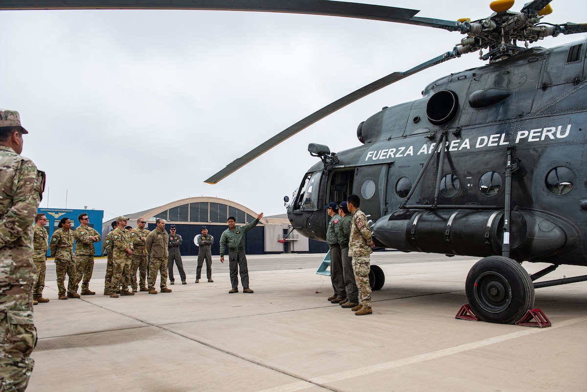 A Peruvian Air Force pilot gives a familiarization tour of a MIL Mi - 17 helicopter during Resolute Sentinel 2024 in Lima, Peru, June 3, 2024. RS24 is a three-week exercise that will integrate combat interoperability and disaster response training. (U.S. Air force photo by Airman 1st Class Sir Wyrick)