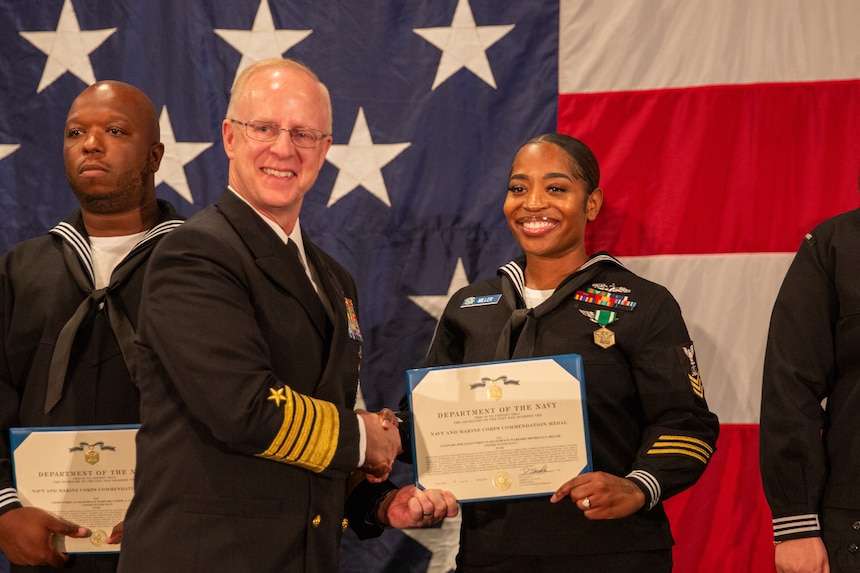 NORFOLK, Va. (June 6, 2024) Adm. Daryl Caudle, commander, U.S. Fleet Forces Command (USFFC), presents the Navy and Marine Corps commendation medal to Culinary Specialist 1st Class Michelle Miller during the 2024 USFFC Sailor of the Year announcement dinner, June 6th 2024. The dinner is the culmination of a weeklong series of events that concludes with the announcement of the 2023 sea and shore Sailors of the Year. Sea and Shore Sailors of the Year will be meritoriously advanced to chief petty officer. (U.S. Navy photo by Mass Communication Specialist 1st Class Evan Thompson/Released)