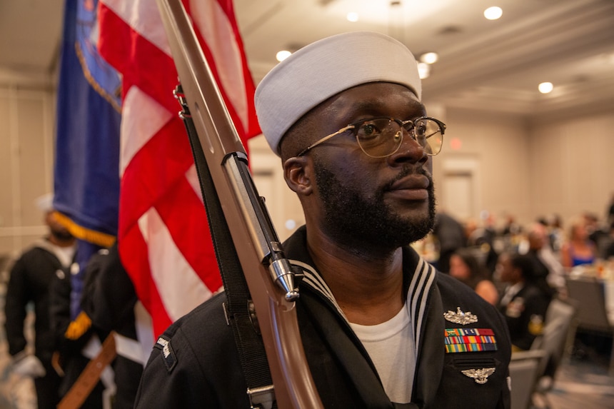 NORFOLK, Va. (June 6, 2024) Personnel Specialist 1st Class Kangni Somado Folly, assigned to U.S. Fleet Forces Command (USFFC), performs as part of the color guard during the 2024 Sailor of the Year announcement dinner, June 6th, 2024. The dinner is the culmination of a weeklong series of events that concludes with the announcement of the 2023 sea and shore Sailors of the Year. Sea and Shore Sailors of the Year will be meritoriously advanced to chief petty officer. (U.S. Navy photo by Mass Communication Specialist 1st Class Evan Thompson/Released)