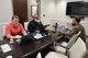 Physical Scientist Brian Choate and Environmental Engineer Alou Rice sit at a wood table with a City of Atlanta official at City Hall.