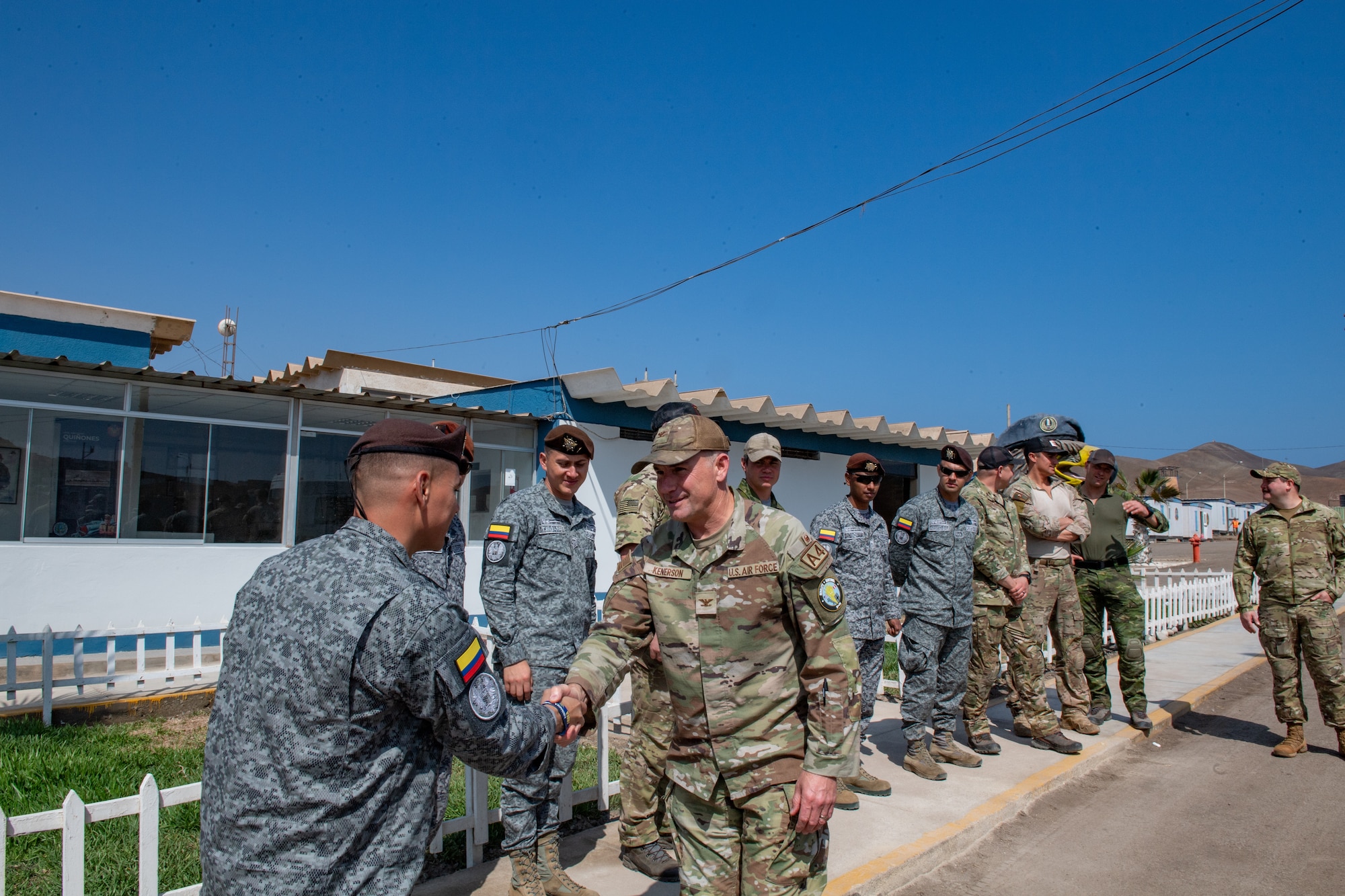U.S. Air Force Col. Barton Kenerson, Combined Joint Task Force - Resolute Sentinel 24 commander, shakes hands with a member from the Special Forces Group at GRUFE during exercise Resolute Sentinel in Lima, Peru, June 3, 2024. Exercise RS24 provides an opportunity to hone the capabilities of partner nation for disaster response, security operations and humanitarian assistance. (U.S. Air Force photo by Senior Airman Courtney Sebastianelli)