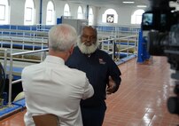 Environmental Engineer Alou Rice gives an interview to a reporter in a white shirt at the Hemphill Water Treatment Facility in Atlanta.
