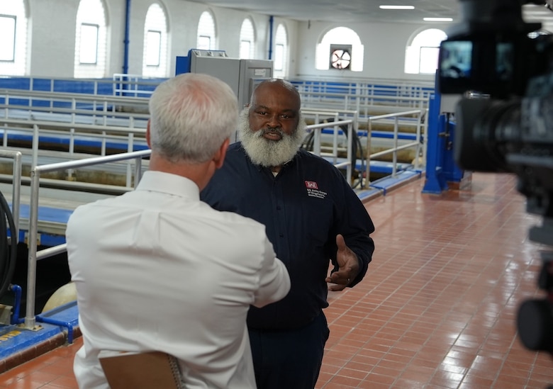 Environmental Engineer Alou Rice gives an interview to a reporter in a white shirt at the Hemphill Water Treatment Facility in Atlanta.