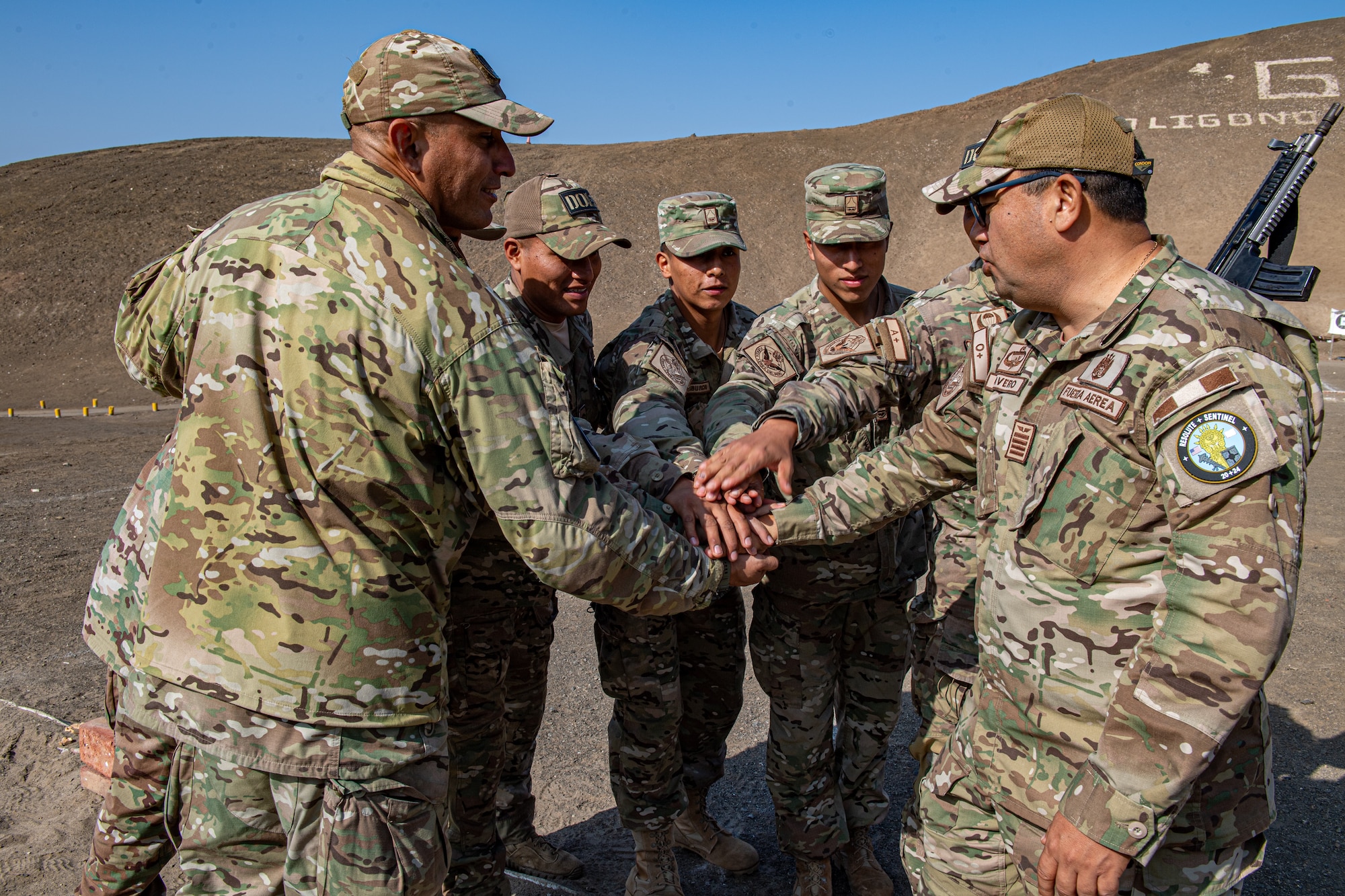 Peruvian military members assigned to GRUFE demonstrate a team chant during a base tour with the Combined Joint Task Force – Resolute Sentinel 2024 leadership in Lima, Peru, June 3, 2024. The tour also provided a platform for both nations to appreciate the geographical and operational challenges unique to Peru, which include diverse terrains such as coastlines, mountains and jungles. (U.S. Air Force photo by Senior Airman Courtney Sebastianelli)