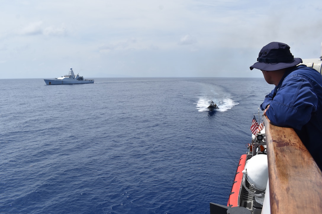 The Commanding Officer of Coast Guard Cutter Resolute (WMEC 620) Cmdr. Mike Ross oversees a bulk contraband transfer with the Royal Netherlands Navy HNMLS Groningen (P843) in the Caribbean Sea, May 20, 2024. Resolute onloaded over 2,700 kg of contraband seized by the Groningen and an embarked Coast Guard law enforcement team. (U.S. Coast Guard photo courtesy of Resolute)