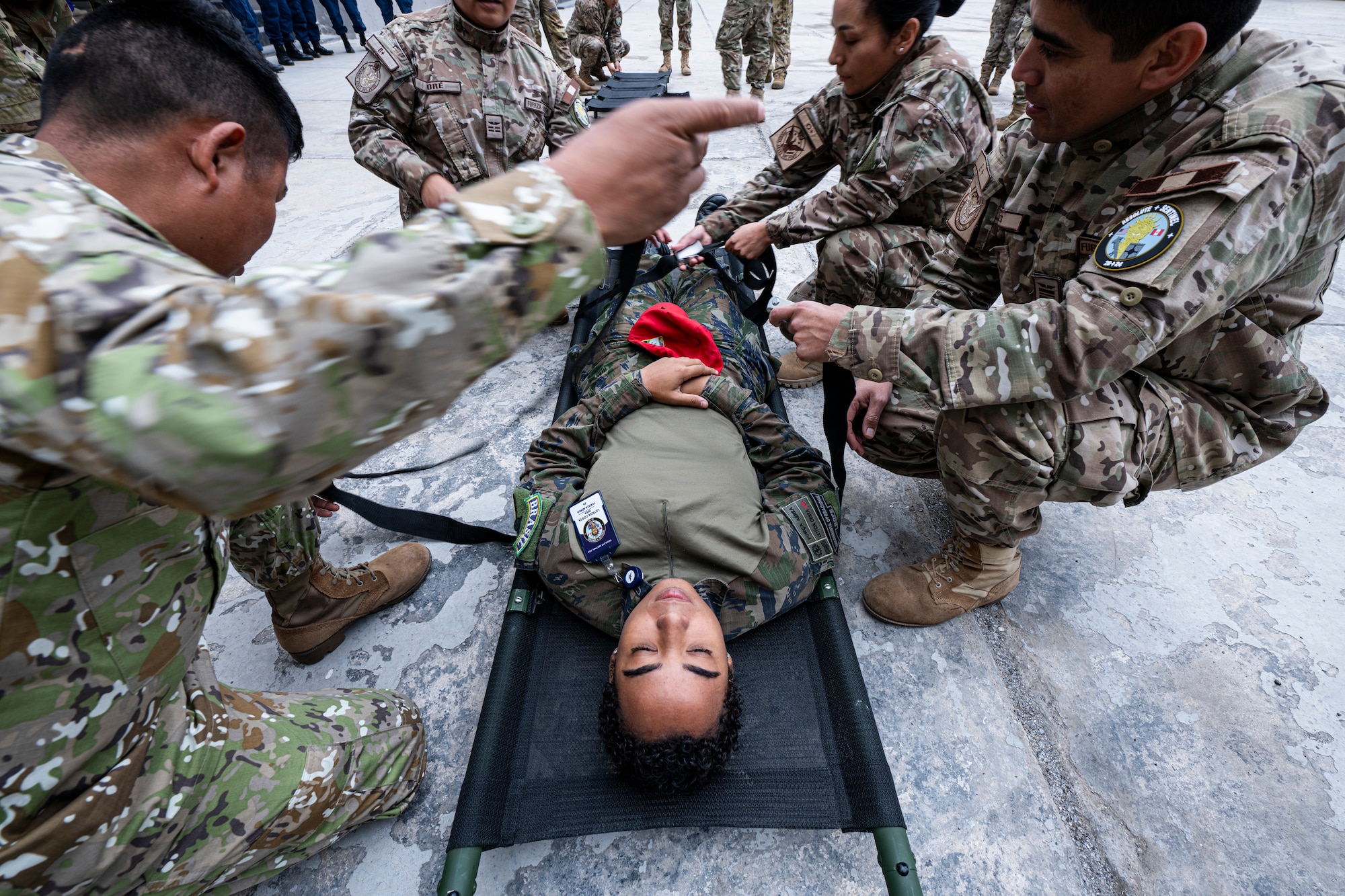 Peruvian and Brazilian armed forces personnel practice Tactical Combat Casualty Care (TCCC) procedures as part of exercise Resolute Sentinel 2024 at Las Palmas Air Base in Lima, Peru, June 4, 2024. The Peruvians and Brazilians engaged in hands-on simulations and lectures led by experienced medical personnel assigned to the 167th Aeromedical Evacuation Squadron from McLaughlin Air National Guard Base, West Virginia. The Resolute Sentinel exercise honors the U.S. promise to be a trusted partner in the region by increasing collaboration, enhancing interoperability, and building partner nation capacity so that partners can quickly work together when support is needed. (U.S. Air Force photo by Tech. Sgt. Devin Boyer)