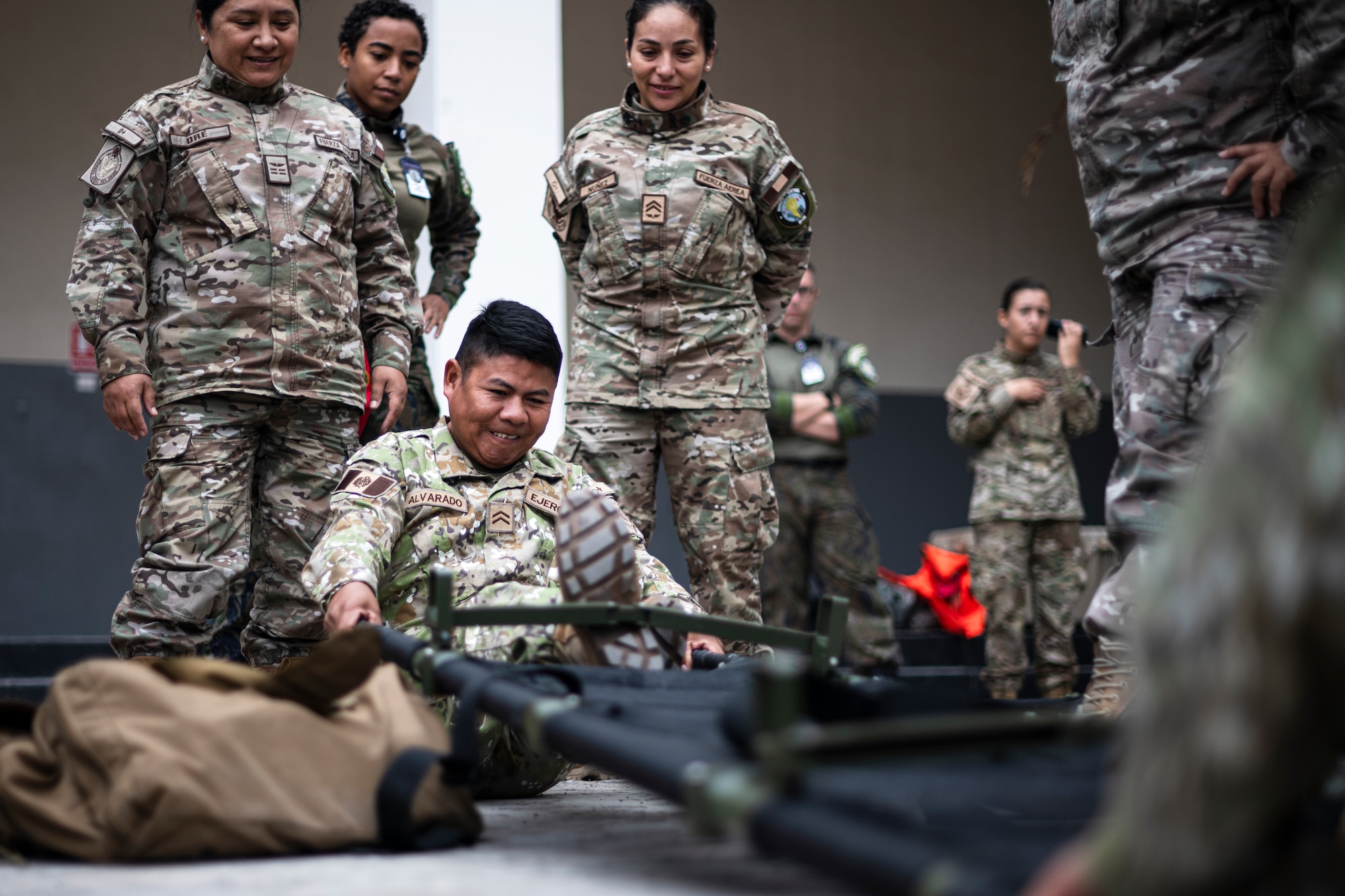 A Peruvian Army medical professional collapses a litter for a Tactical Combat Casualty Care (TCCC) course as part of exercise Resolute Sentinel 2024 at Las Palmas Air Base in Lima, Peru, June 4, 2024. The TCCC course, led by U.S. Air Force aeromedical personnel, aimed to enhance the medical readiness and interoperability of the participating countries, ensuring they are better prepared to handle combat injuries in various operational scenarios. The Resolute Sentinel exercise honors the U.S. promise to be a trusted partner in the region by increasing collaboration, enhancing interoperability, and building partner nation capacity so that partners can quickly work together when support is needed. (U.S. Air Force photo by Tech. Sgt. Devin Boyer)