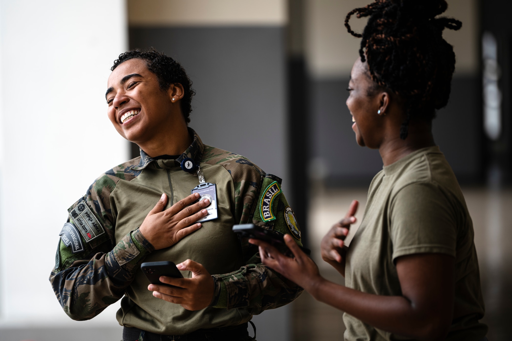 A Brazilian Air Force medical professional, left, and a U.S. Air Force Airman assigned to the 167th Aeromedical Evacuation Squadron from McLaughlin Air National Guard Base, West Virginia, communicate with translation applications on their mobile devices as part of exercise Resolute Sentinel 2024 at Las Palmas Air Base in Lima, Peru, June 4, 2024. Medical professionals from Peruvian, Brazilian, and U.S. armed forces built relationships through a week-long Tactical Combat Casualty Care course where they strengthened combat medical capabilities. The Resolute Sentinel exercise honors the U.S. promise to be a trusted partner in the region by increasing collaboration, enhancing interoperability, and building partner nation capacity so that partners can quickly work together when support is needed. (U.S. Air Force photo by Tech. Sgt. Devin Boyer)