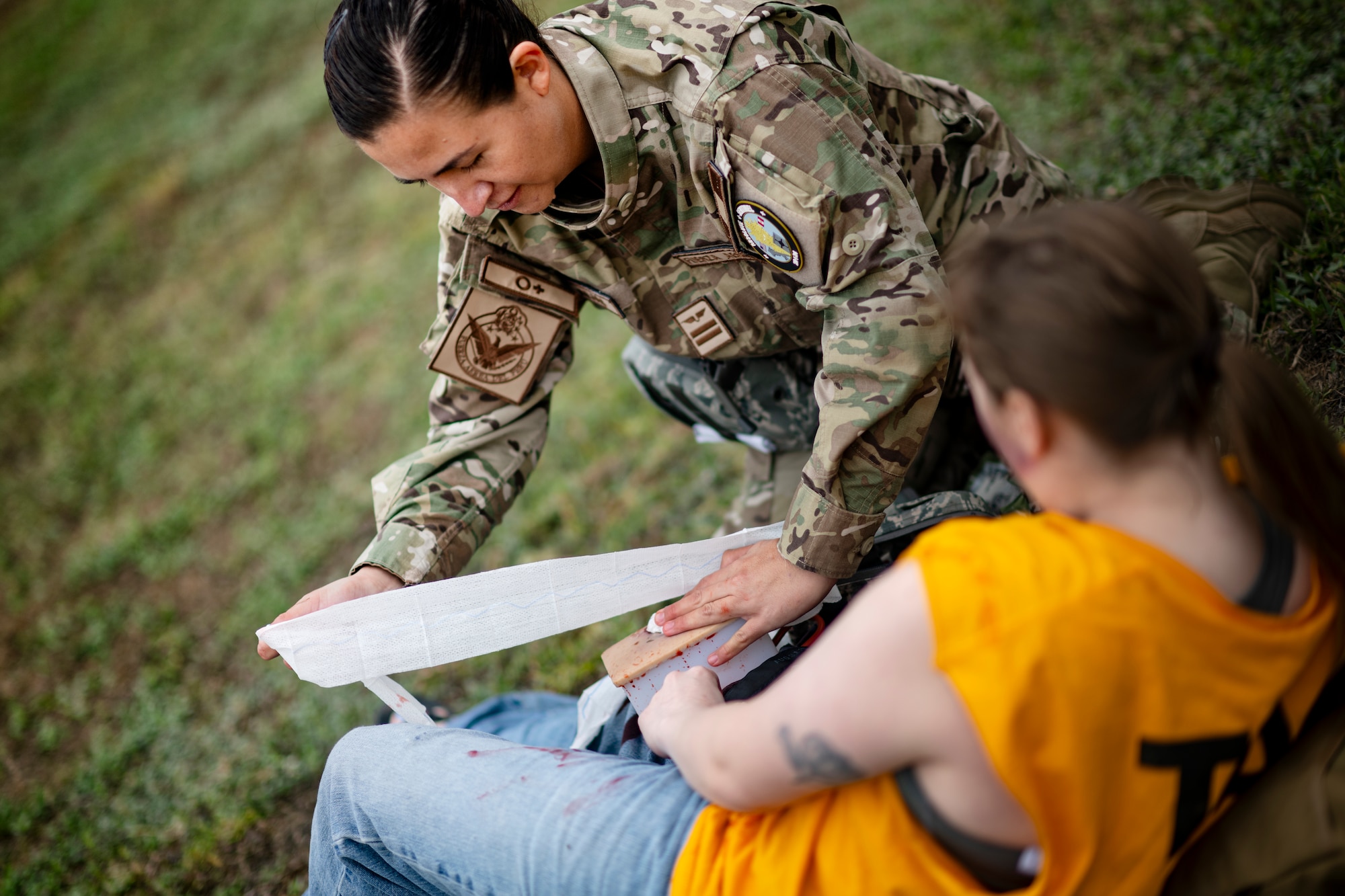 A Peruvian Air Force medical professional conducts Tactical Combat Casualty Care on a U.S. Air Force Airman assigned to the 167th Aeromedical Evacuation Squadron from McLaughlin Air National Guard Base, West Virginia, as part of exercise Resolute Sentinel 2024 at Las Palmas Air Base in Lima, Peru, June 4, 2024. Partner nations took turns conducting a training scenario where they provided care to wounded Airmen in a simulated hostile environment. The Resolute Sentinel exercise honors the U.S. promise to be a trusted partner in the region by increasing collaboration, enhancing interoperability, and building partner nation capacity so that partners can quickly work together when support is needed. (U.S. Air Force photo by Tech. Sgt. Devin Boyer)