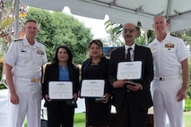 Vice Adm. Johnny Wolfe Jr., director of U.S. Navy Strategic Systems Programs (left); Suzanne Nicolas (next to left); Julissa Simental (center); Ed Vicuna (next to right); and Capt. Neil Sexton, Engineering Duty Officer (EDO) Schoolhouse commander (right), pose for a photo during the fiftieth anniversary luncheon for the EDO School Thursday, June 6. Nicolas, Simental, and Vicuna were awarded Navy Civilian Service Commendations for a combined 50 years of educating students on civilian workforce, labor relations, and equal employment matters. The school-established in 1974 and founded by Naval Sea Systems Command Commander Vice Adm. Robert C. Gooding-provides education to improve the professional proficiency of EDOs through training in plans, programs, policies, and procedures that drive the life-cycle engineering of naval ships and systems. (U.S. Navy Photo by Lt. Jennifer Bowman/Released)