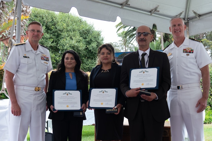Vice Adm. Johnny Wolfe Jr., director of U.S. Navy Strategic Systems Programs (left); Suzanne Nicolas (next to left); Julissa Simental (center); Ed Vicuna (next to right); and Capt. Neil Sexton, Engineering Duty Officer (EDO) Schoolhouse commander (right), pose for a photo during the fiftieth anniversary luncheon for the EDO School Thursday, June 6. Nicolas, Simental, and Vicuna were awarded Navy Civilian Service Commendations for a combined 50 years of educating students on civilian workforce, labor relations, and equal employment matters. The school-established in 1974 and founded by Naval Sea Systems Command Commander Vice Adm. Robert C. Gooding-provides education to improve the professional proficiency of EDOs through training in plans, programs, policies, and procedures that drive the life-cycle engineering of naval ships and systems. (U.S. Navy Photo by Lt. Jennifer Bowman/Released)