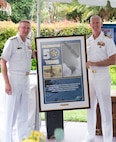 Vice Adm. Johnny Wolfe Jr., director of U.S. Navy Strategic Systems Programs (SSP) (left) presents a gift to Capt. Neil Sexton, Engineering Duty Officer (EDO) Schoolhouse commander (right), in honor of the school's fiftieth anniversary EDO School Thursday, June 6. SSP is the Navy command that provides cradle-to-grave lifecycle support for the sea-based leg of the nation's nuclear triad and for approximately 70 percent of the U.S.'s deployed strategic nuclear assets. EDOs supporting SSP are responsible to ensure the strategic weapon system is deployable and ready to support the vital strategic deterrence mission of America's Warfighting Navy. The EDO school-established in 1974 and founded by Naval Sea Systems Command Commander Vice Adm. Robert C. Gooding-provides education to improve the professional proficiency of EDOs through training in plans, programs, policies, and procedures that drive the life-cycle engineering of naval ships and systems. (U.S. Navy Photo by Lt. Jennifer Bowman/Released)