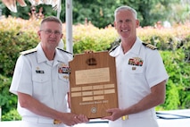 Vice Adm. Johnny Wolfe Jr., director of U.S. Navy Strategic Systems Programs (SSP) (left) is recognized with the Navy's 'Old Ironsides' plaque by Capt. Neil Sexton, Engineering Duty Officer (EDO) Schoolhouse commander (right), during the school's fiftieth anniversary luncheon Thursday, June 6. SSP is the Navy command that provides cradle-to-grave lifecycle support for the sea-based leg of the nation's nuclear triad and for approximately 70 percent of the U.S.'s deployed strategic nuclear assets. EDOs supporting SSP are responsible to ensure the strategic weapon system is deployable and ready to support the vital strategic deterrence mission of America's Warfighting Navy. The EDO school-established in 1974 and founded by Naval Sea Systems Command Commander Vice Adm. Robert C. Gooding-provides education to improve the professional proficiency of EDOs through training in plans, programs, policies, and procedures that drive the life-cycle engineering of naval ships and systems. (U.S. Navy Photo by Lt. Jennifer Bowman/Released)