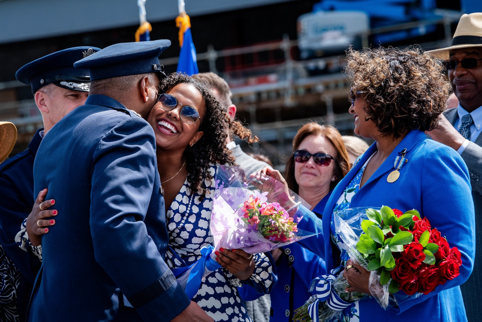 Lt. Gen. Richard M. Clark presents flowers to his daughter, Zoe, and wife, Amy