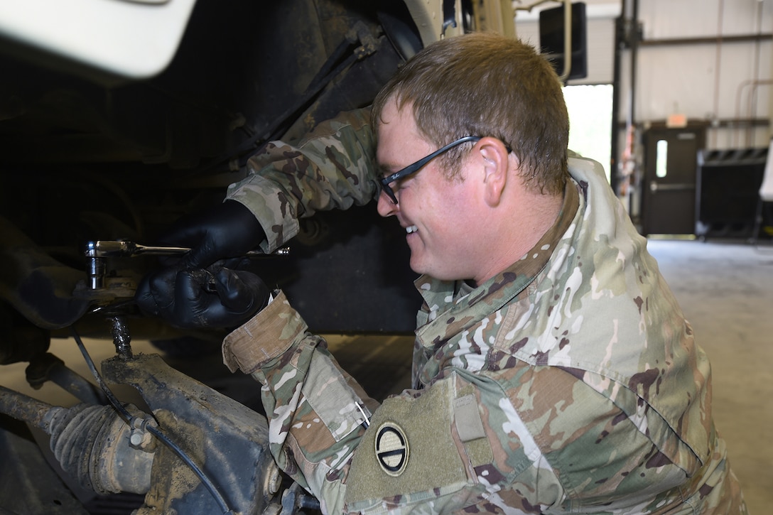 U.S. Army Reserve Spc. Seth Hensarling, Mechanic, 3-349th Logistical Support Battalion, Camp Shelby, Mississippi, installs a new ball joint on a Humvee brought in for service during Exportable Combat Training Capability 24-01, June 3, 2024.