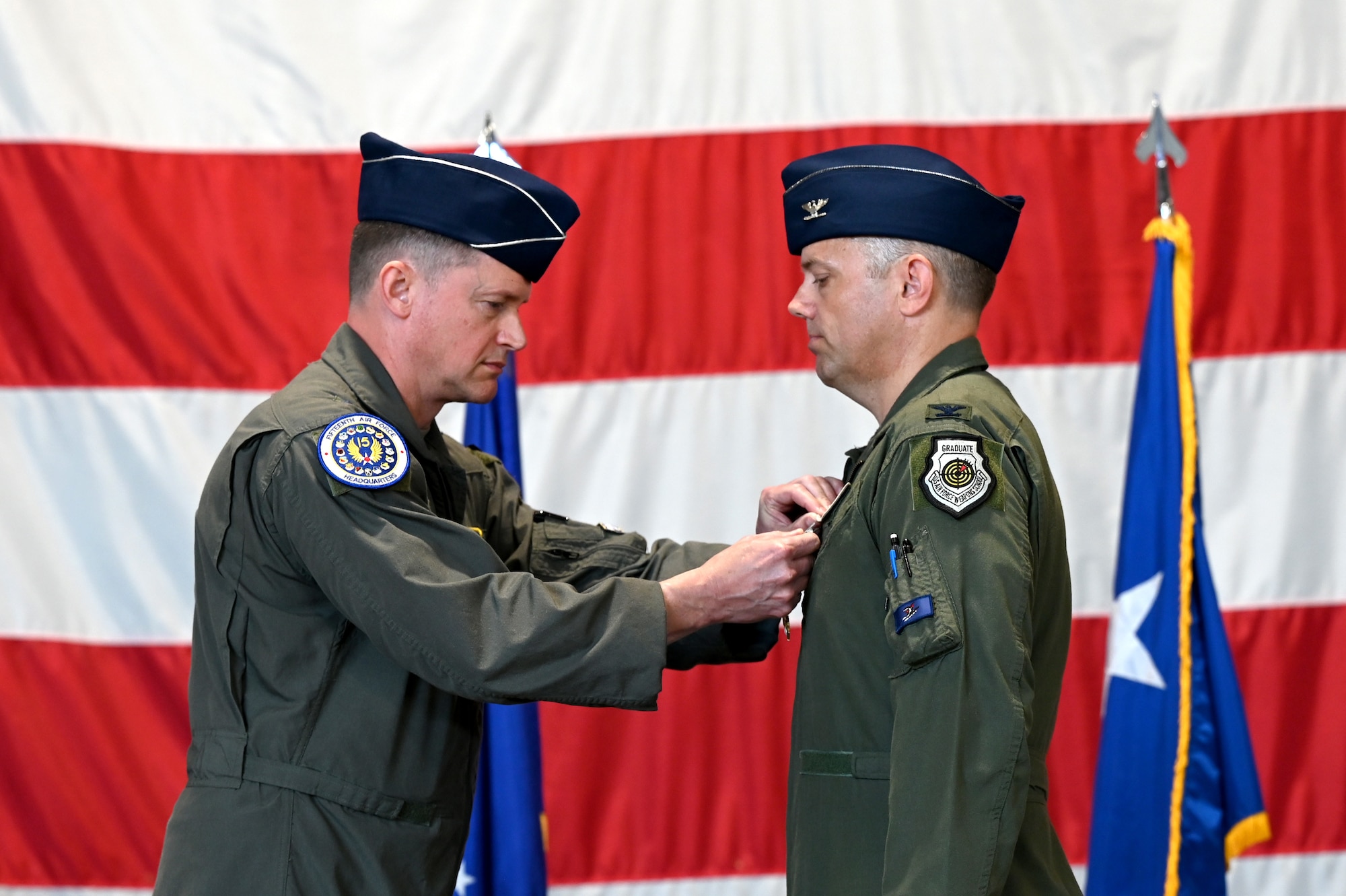 U.S. Air Force Maj. Gen. David Lyons, Fifteenth Air Force commander, left, presents the Legion of Merit to Col. Kristoffer Smith, outgoing 20th Fighter Wing commander, during a change of command ceremony at Shaw Air Force Base, S.C., June 7, 2024. The Legion of Merit is awarded to U.S. military service members for exceptionally meritorious conduct in the performance of outstanding service to the United States. (U.S. Air Force photo by Staff Sgt. Kelsey Owen)