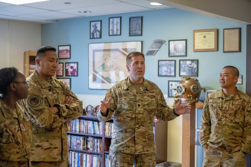 a military medical professional addresses other military medics in a room