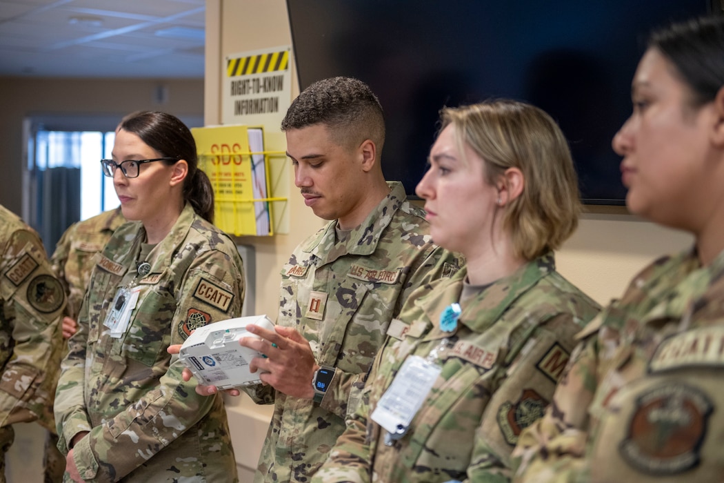 military members look at new hospital equipment
