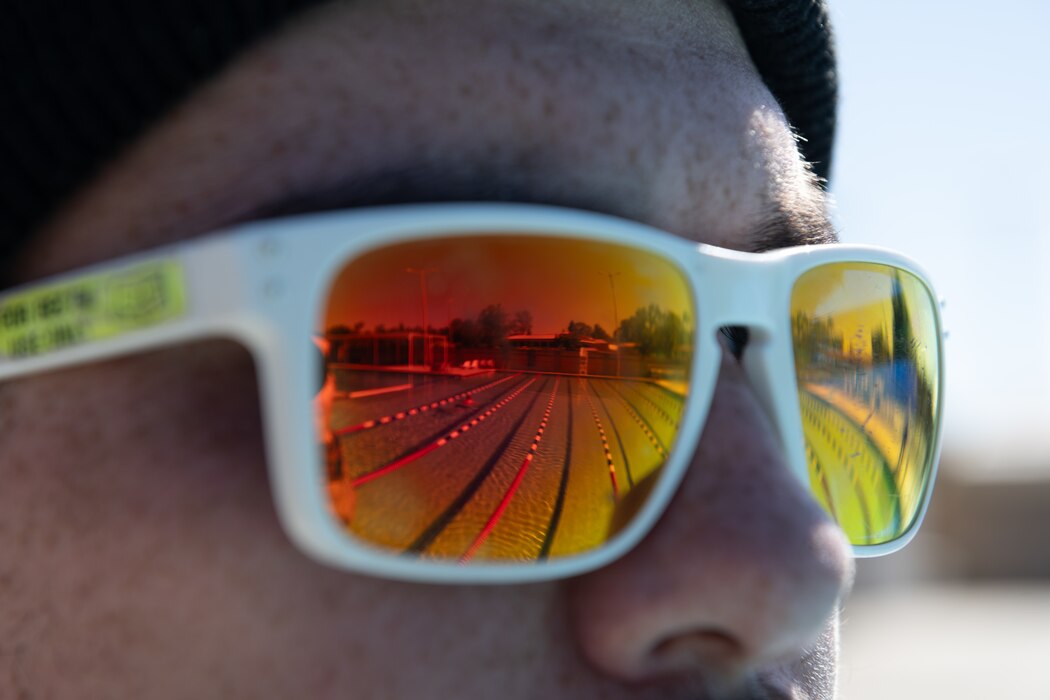 Close-up reflection of pool off lifeguard glasses.