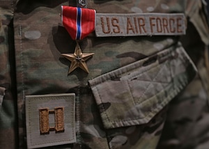 A Bronze Star Medal is awarded to a Captain combat rescue officer assigned to the 48th Rescue Squadron in the base theater at Davis-Monthan Air Force Base, Ariz., June 7, 2024.  The Bronze Star was awarded for heroic service during Operation Allies Refuge from August 15 to August 29, 2021, at the Hamid Karzai International Airport in Kabul, Afghanistan. (U.S. Air Force photo by Staff Sgt. Abbey Rieves)
